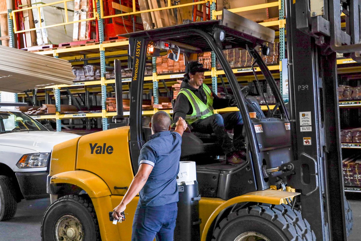 GSL San Rafael staff on forklift greeting customer in lumberyard