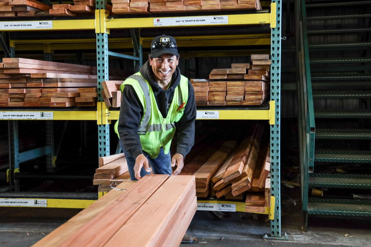 Staff smiling while stocking lumber at GSL San Rafael