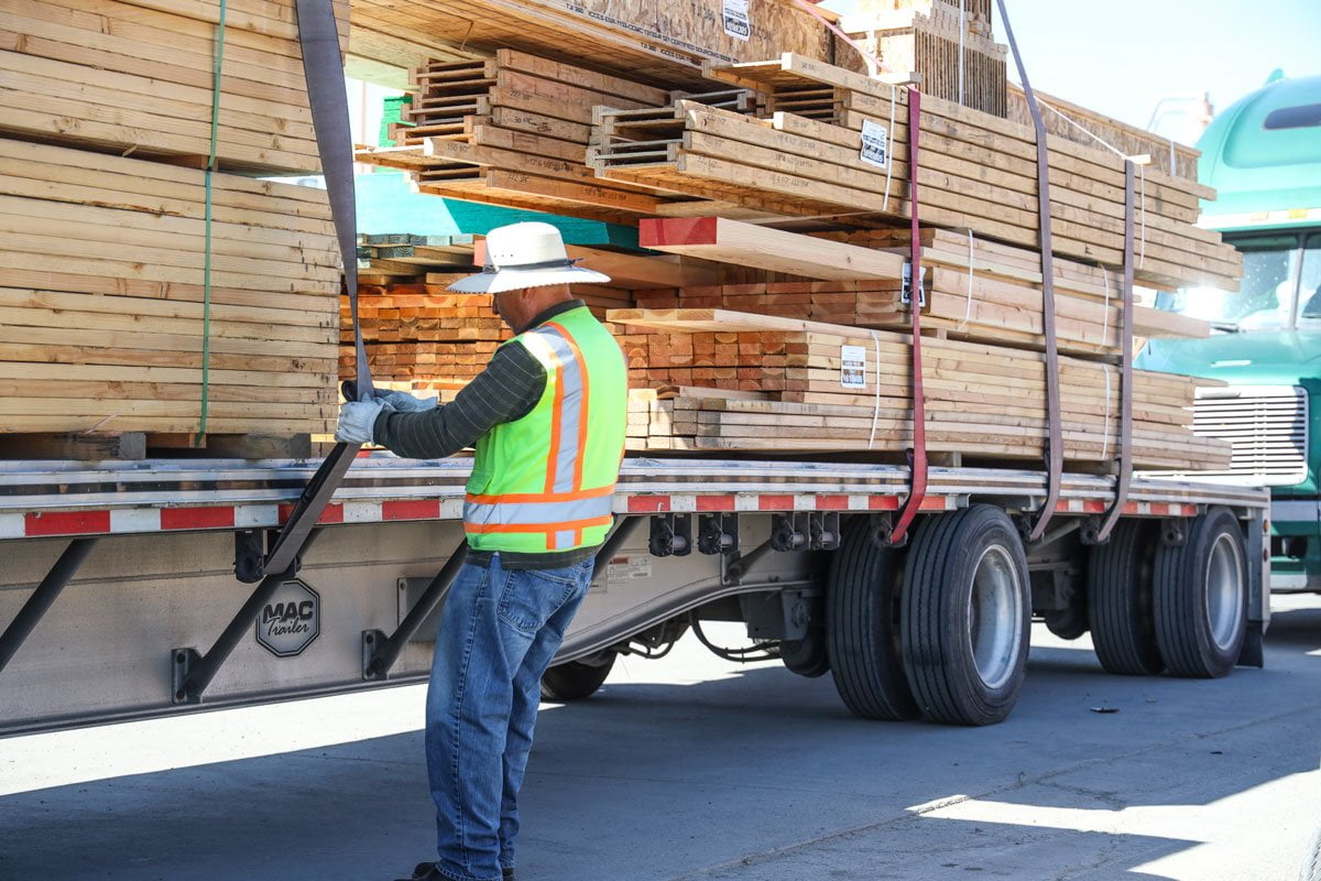 Staff securing lumber to a truck at GSL Stockton
