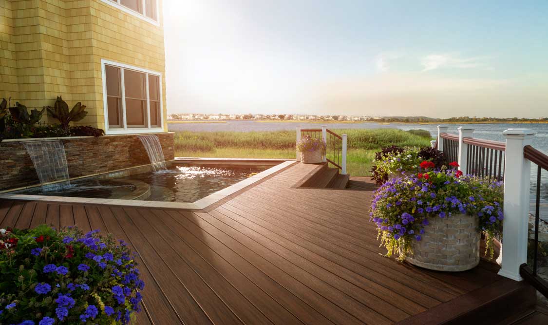 Trex Decking and Railing around pool with a lake view