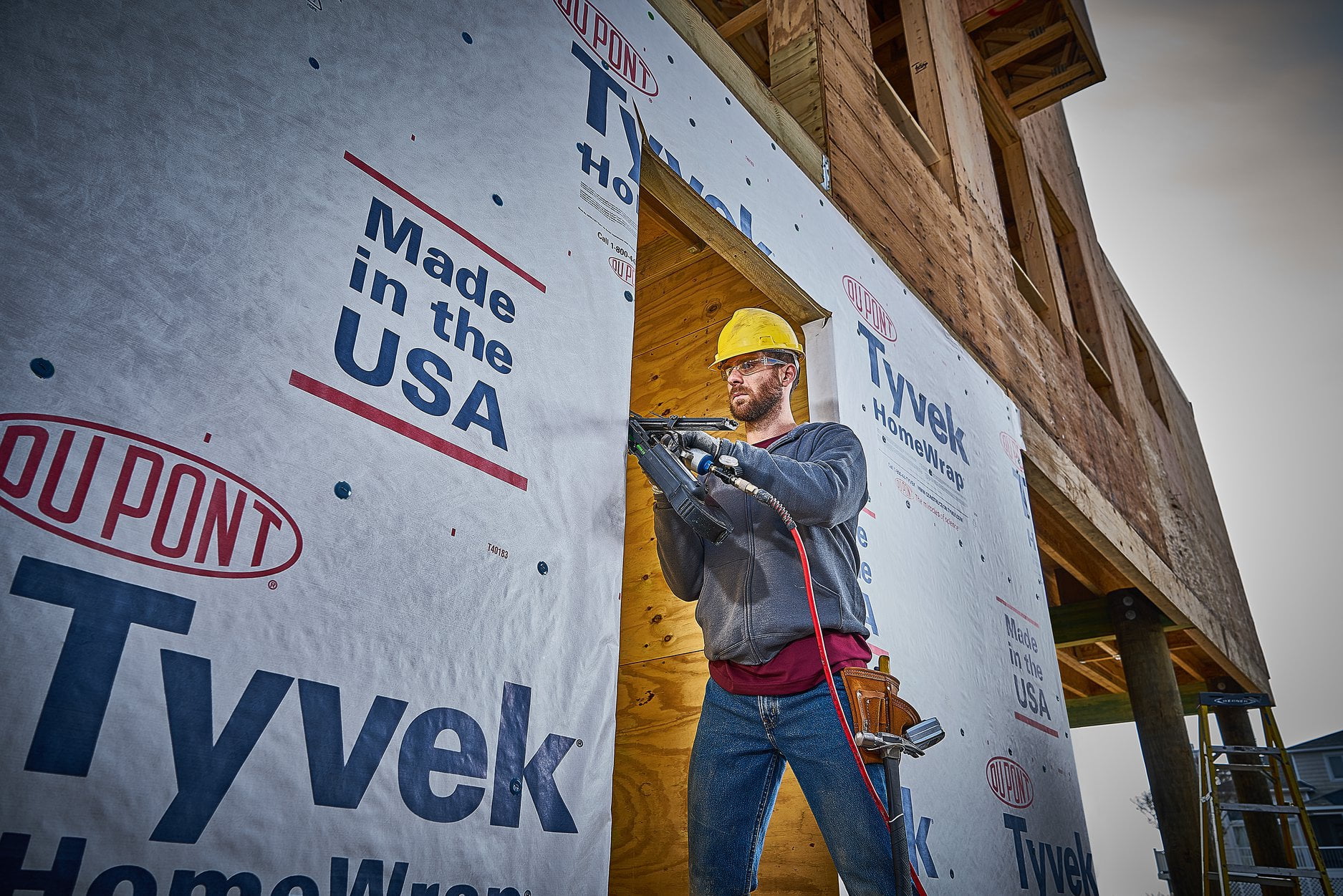 construction work on building with tyvek barrier