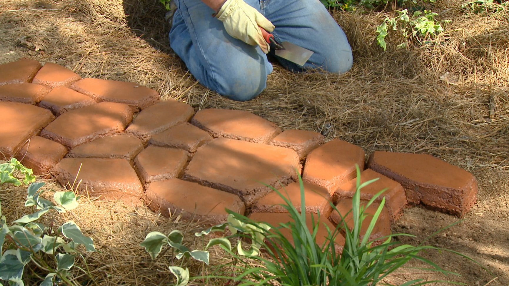 man creating stone walkway with quikrete