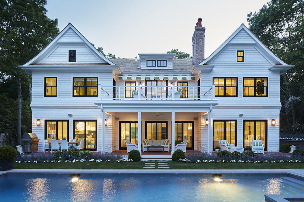 Azek trim on large white home with pool view at sunset
