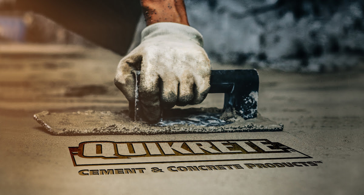 man smoothing out concrete with quikrete logo stamp