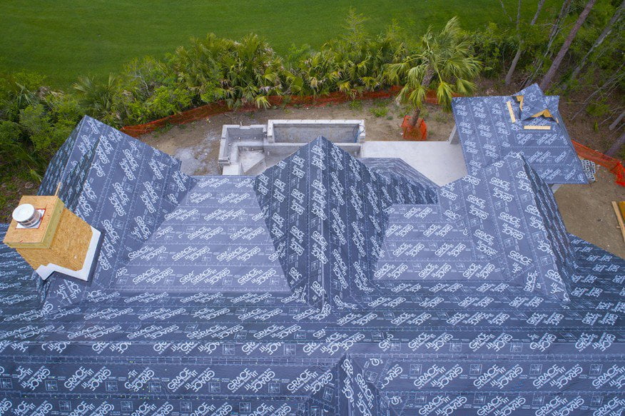 Aerial view of home roof wrapped in GRACE weatherization