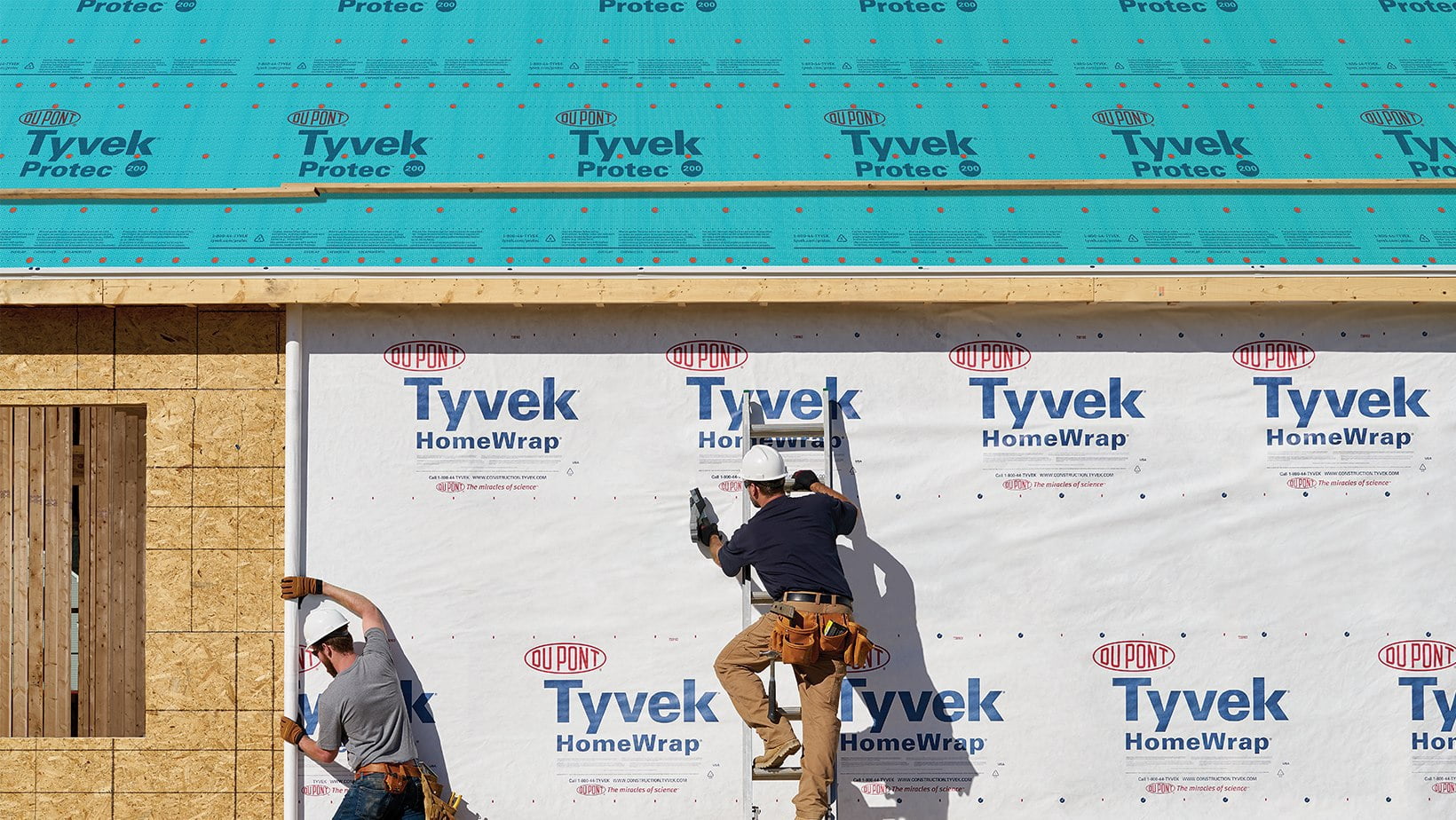 two men applying tyvek barrier