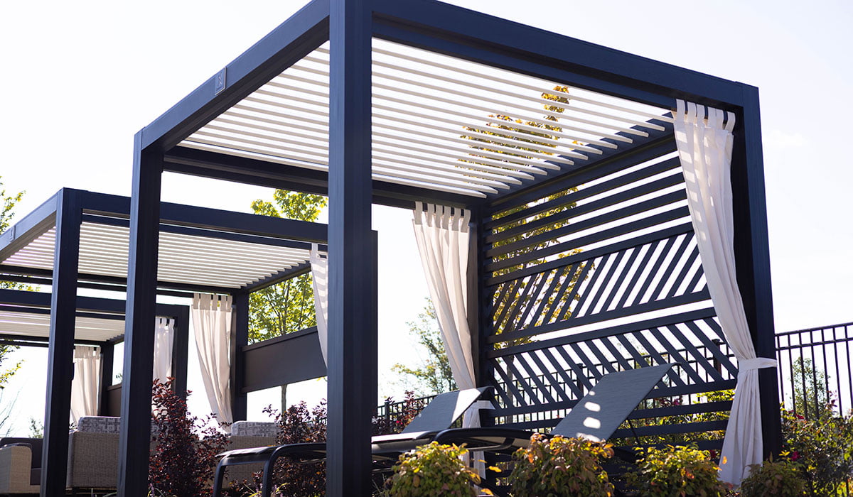 Side view of black StruXure CabanaX in Amber, PA with lounge chairs