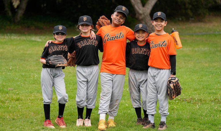 Junior Giants kids team embrace