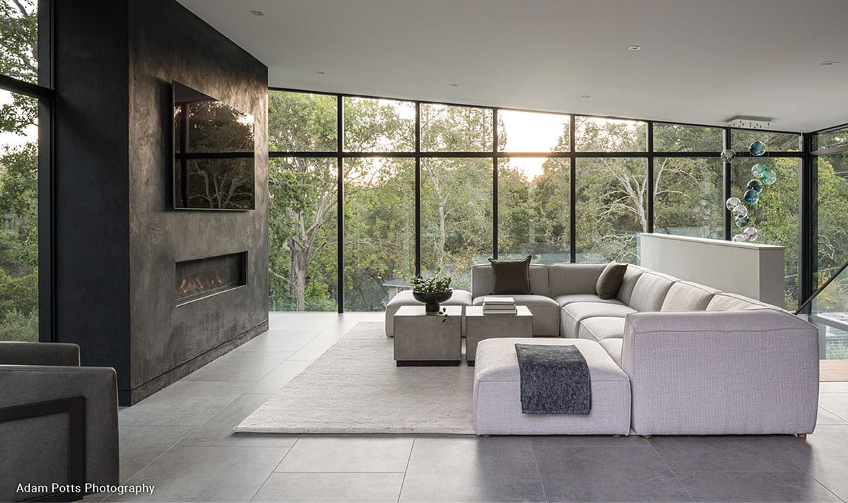 Fleetwood Windows on a slanted living room with a gray stone fireplace