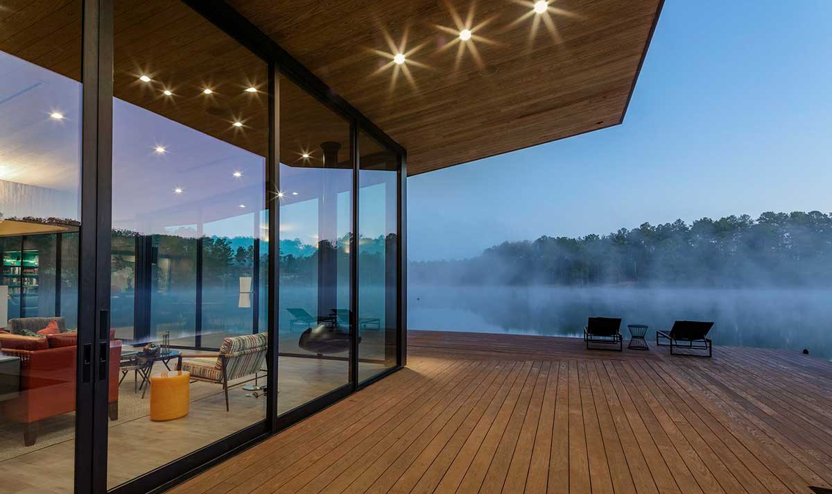 Arbor Wood Co ash deck soffit on lakeside home at dusk