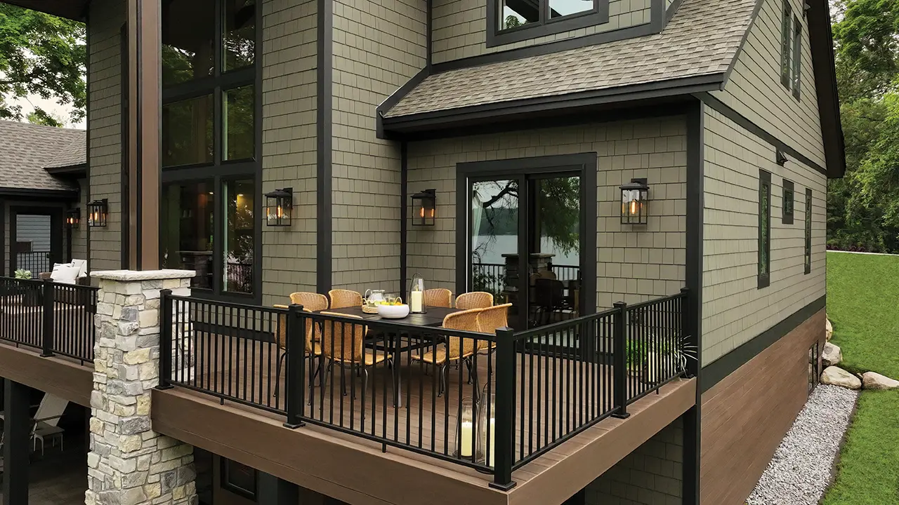 Side view of home with AZEK Exteriors shingle siding and decking in English Walnut