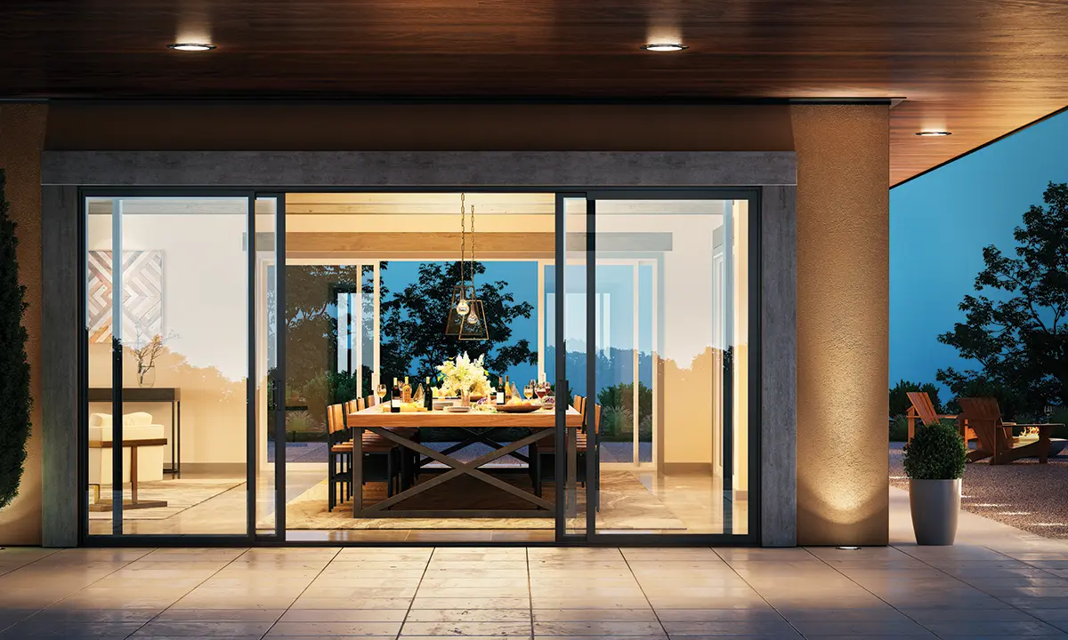 Backyard view into a living room with wall to wall Milgard Trinsic Exterior Vinyl windows and doors