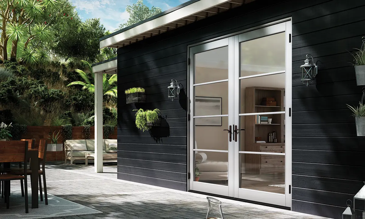 Patio view of home with black cladding and Milgard Tuscany vinyl entry door