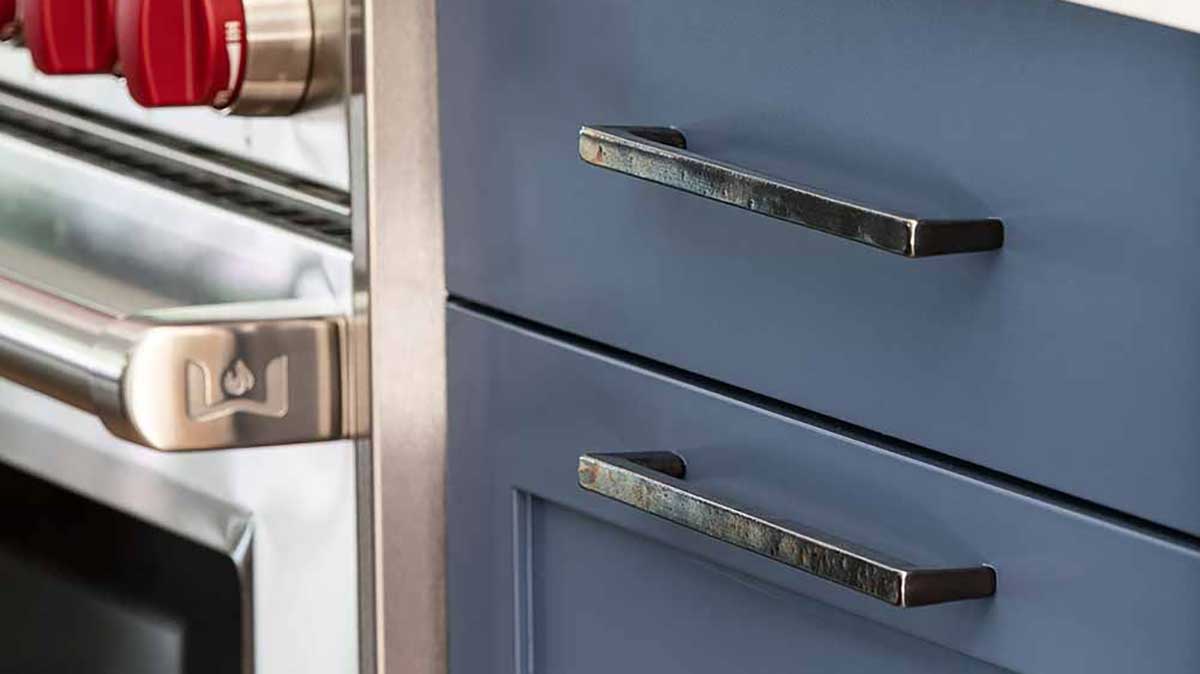Rocky Mountain Hardware cabinet hardware on blue kitchen drawers