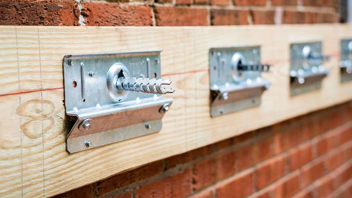 Closeup of Simpson Strong-Tie steel connectors on brick wall