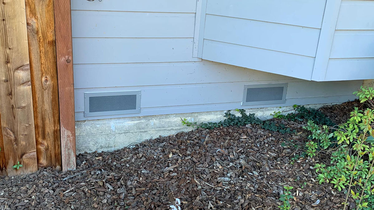 Two Vulcan Vent foundation vents in home backyard