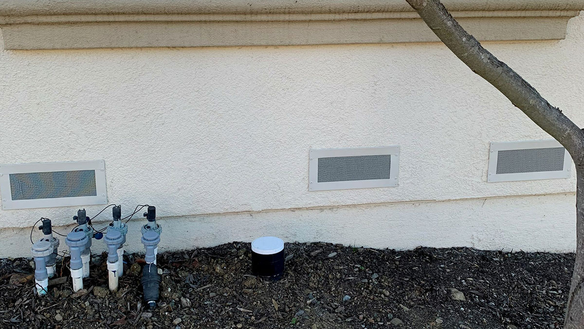 Three Vulcan Vent foundation vents along home exterior