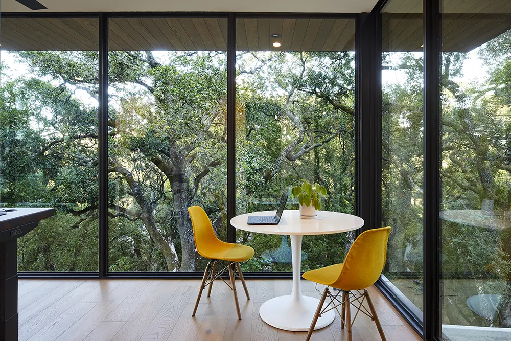 Lafayette home breakfast nook with two yellow chairs and Western Architectural Openings corner windows