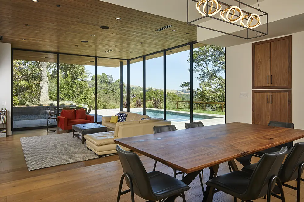 Western Architectural Openings window wall in a Lafayette home living room with dining table