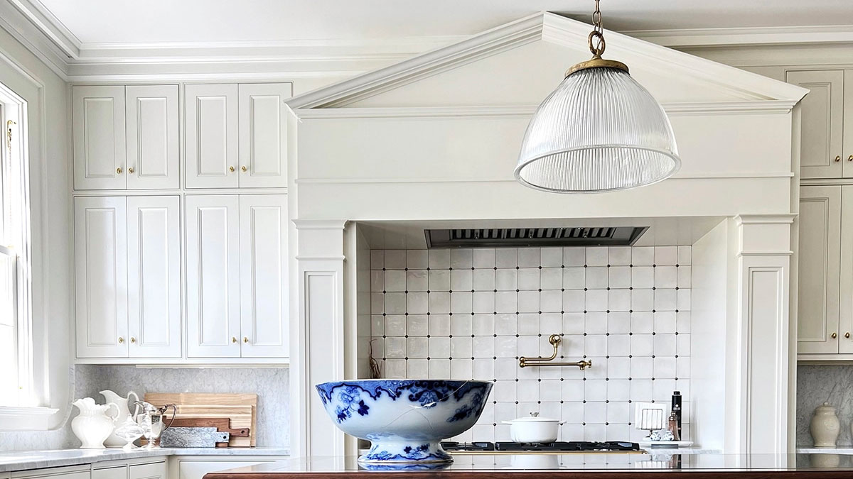 Bright white kitchen with WindsorONE Classical Greek Revival trim and moulding around stove