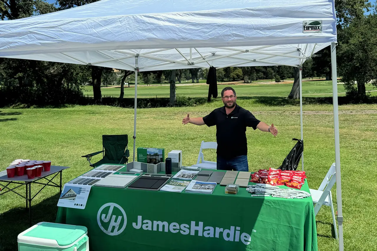 A James Hardie employee stands under a company tent at the annual Golden State Golf Tournament