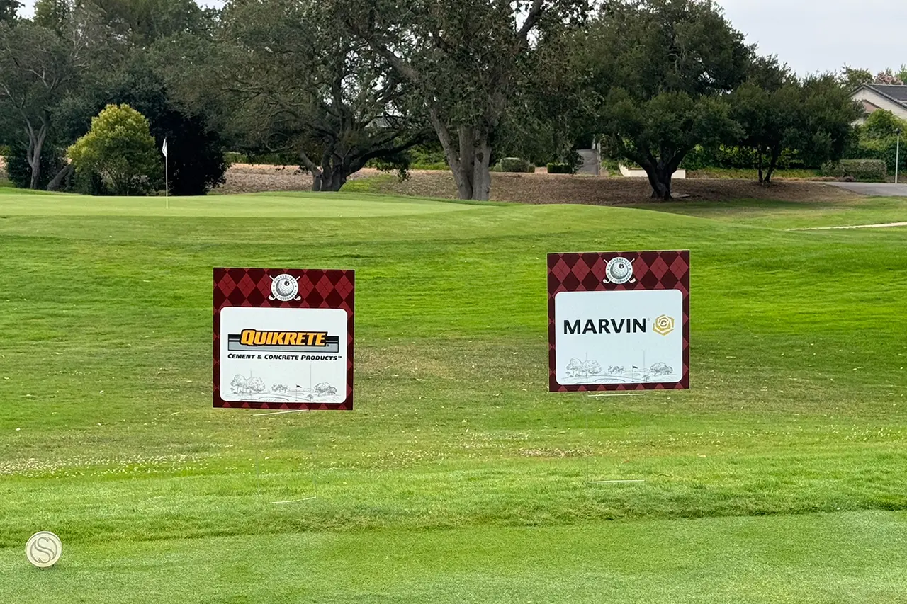 Quikrete and Marvin signs on the golf course