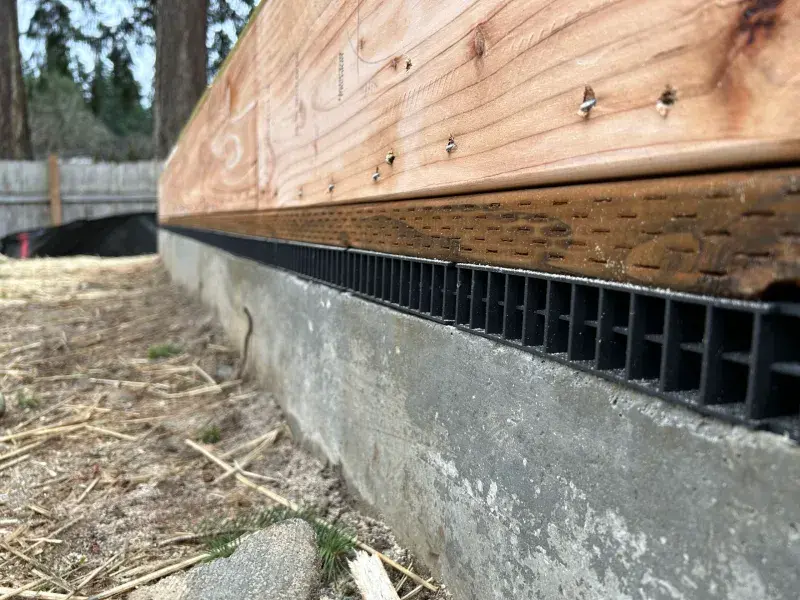 Closeup of a Joto-Vent System Continuous Foundation Vent on a home during construction